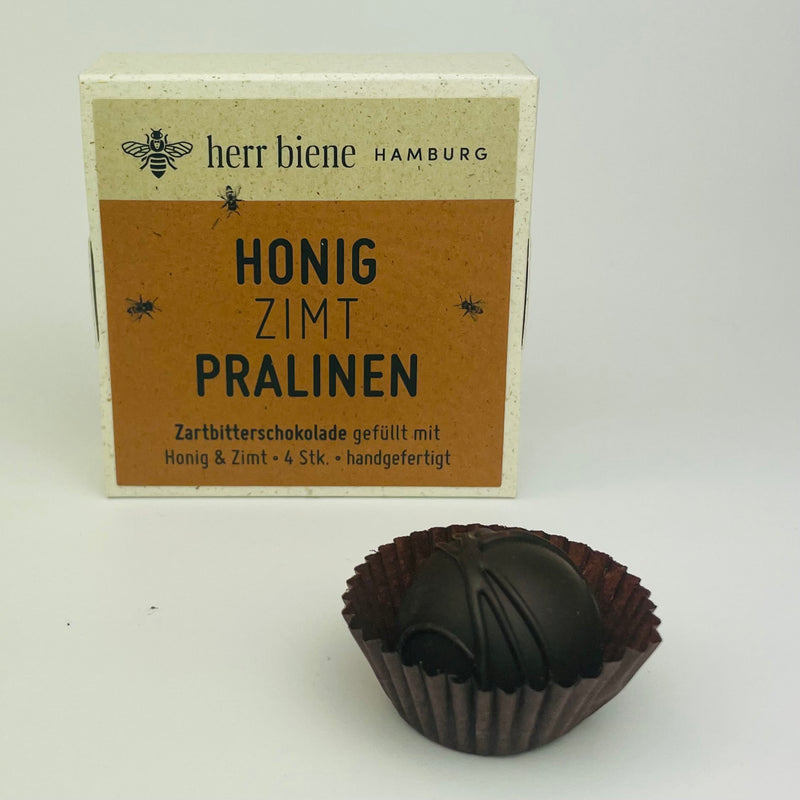 Vier Honigpralinen Zimt mit Zartbitterschokolade in Geschenkverpackung