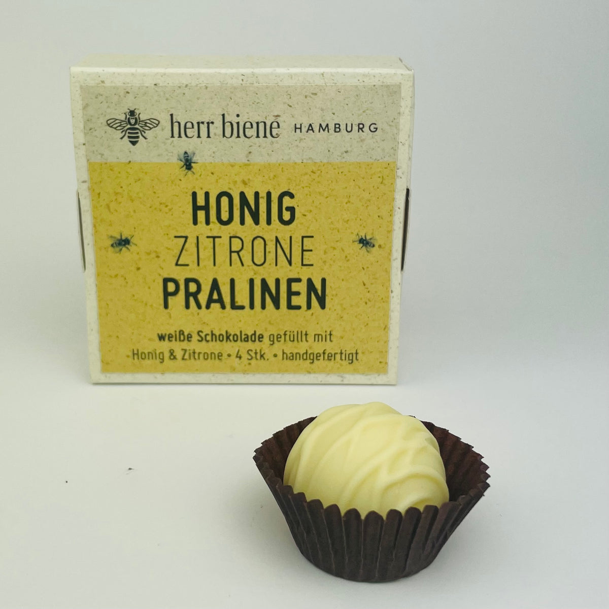 Vier Honigpralinen Zitrone mit Weißer Schokolade in Geschenkverpackung