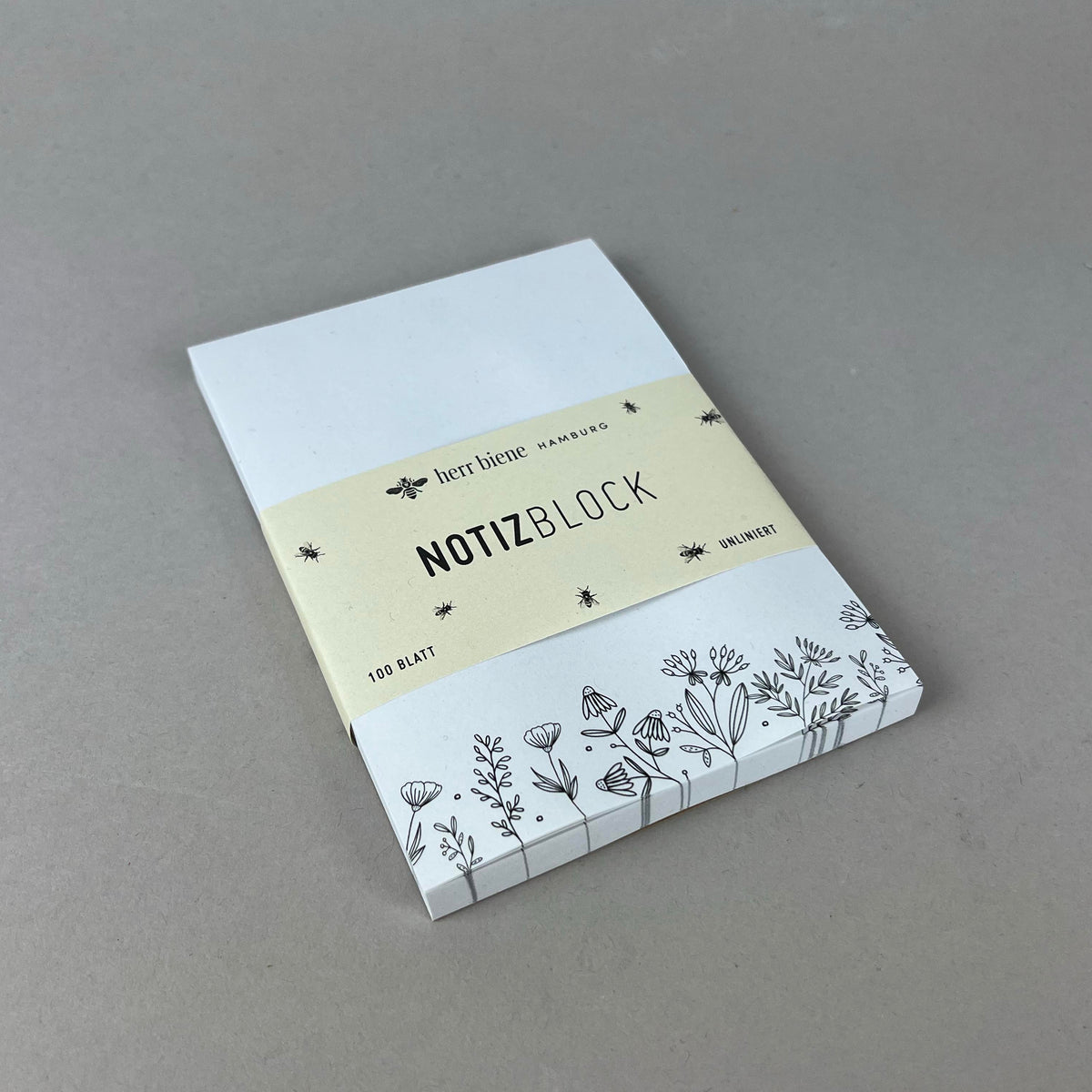Notizblock mit schwarzem Blumenmotiv